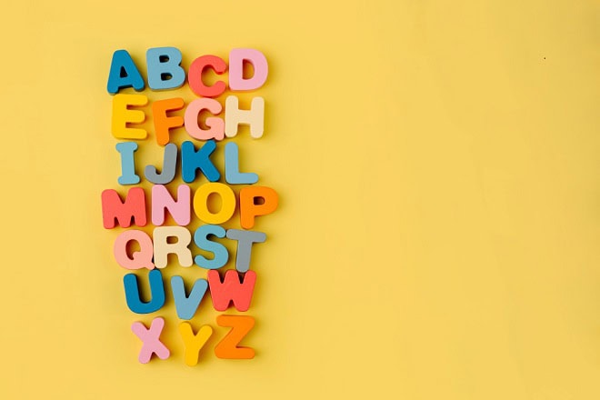 Colorful letters of the alphabet on yellow background. Primary school or preschool, kindergarten. Educational game. Learning through play.