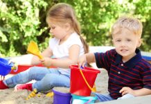Twee kinderen spelen rustig in een zandbak