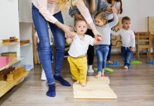 Kids with moms walks on sensory path in montessori