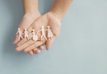 Hands holding diversity family, happpy carer and volunteer, disable nursing home, rehabilitation and health insurance concept
