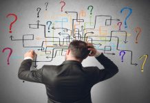 Businessman trying to solve a maze questions