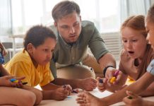 man playing with children on floor