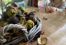 Mandje met herfstspullen als bladeren en kastanjes