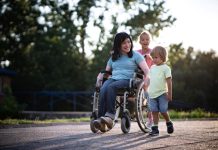 Mother in wheelchair whit her children spending time outdoors