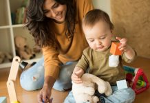 Mother playing with her baby - education methods concept