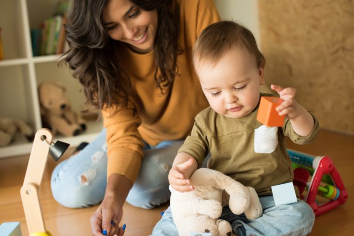 Mother playing with her baby - education methods concept