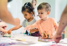 Children finger painting at the nursery school class