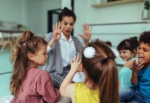 Teacher and cheerful children playing at kindergarten