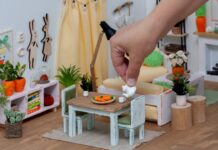 Pp’ers die geen verkleinwoordjes gebruiken: dit zit erachter Een vrolijke, lichte kamer in een poppenhuis, ingericht met miniatuurmeubeltjes. Een persoon schenkt voor de lol thee uit een theepot